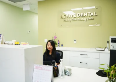 Reception staff member at the front desk of Revive Dental Mississauga, representing Revive Dental Clinic Frequently Asked Question support for patients.