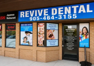 Exterior of Revive Dental Mississauga showing the Revive Dental Clinic storefront, entrance, signage, and dental service displays.