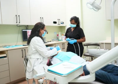 Revive Dental Clinic Gallery at Revive Dental Mississauga showing a dentist and dental assistant providing treatment to a patient in a modern treatment room.