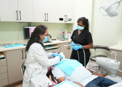 Revive Dental Clinic Treatment Room at Revive Dental Mississauga showing a dentist and dental assistant providing care to a patient in a modern treatment room.