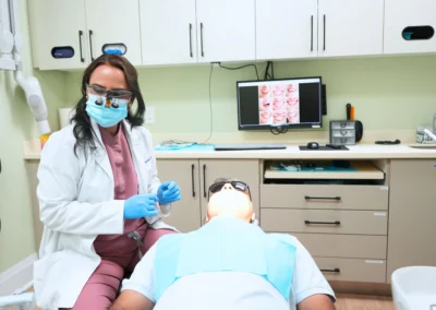 Revive Dental Clinic Treatment at Revive Dental Mississauga showing a dentist preparing to provide dental care to a patient in a modern treatment room.