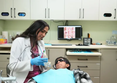 Revive Dental Clinic Treatment at Revive Dental Mississauga showing a dentist using a dental model to explain oral care to a patient in the treatment room.