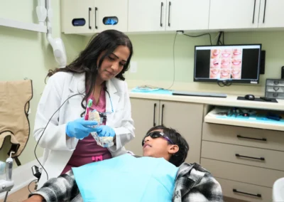 Dentist showing a dental model to a patient during a consultation at Revive Dental Mississauga, highlighting Our Patients Choose Us Because We Offer personalized dental care.